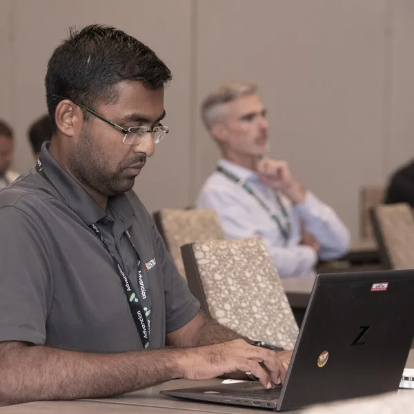 A man on a laptop at the Coatings Trends & Technologies Summit